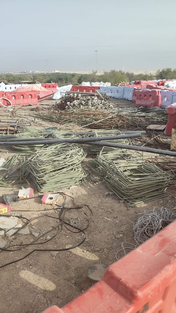 Bundled reinforcement bars and stacked metal at a large construction yard